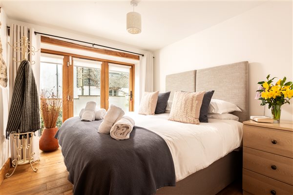 Bedroom with furniture and glazed doors to the terrace